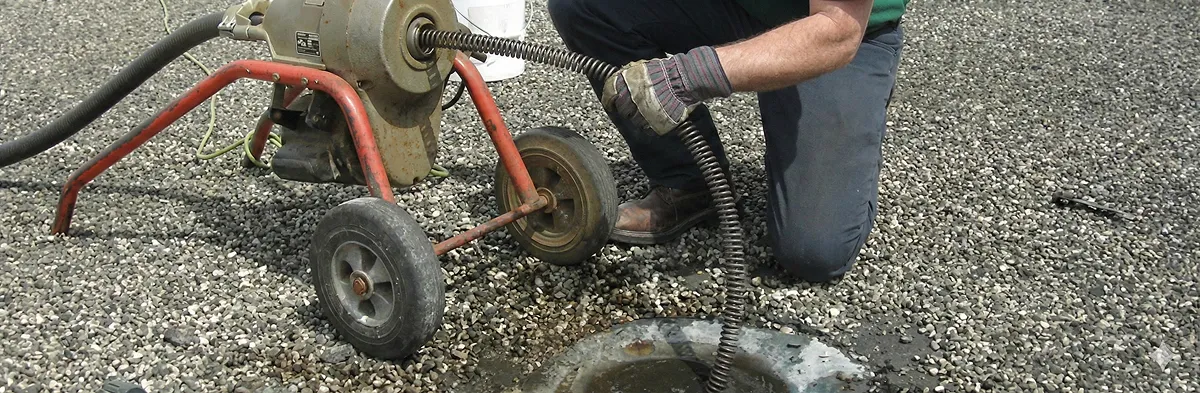 sewer rodding technician actively removing blockages from a sewer line in Arlington, TX